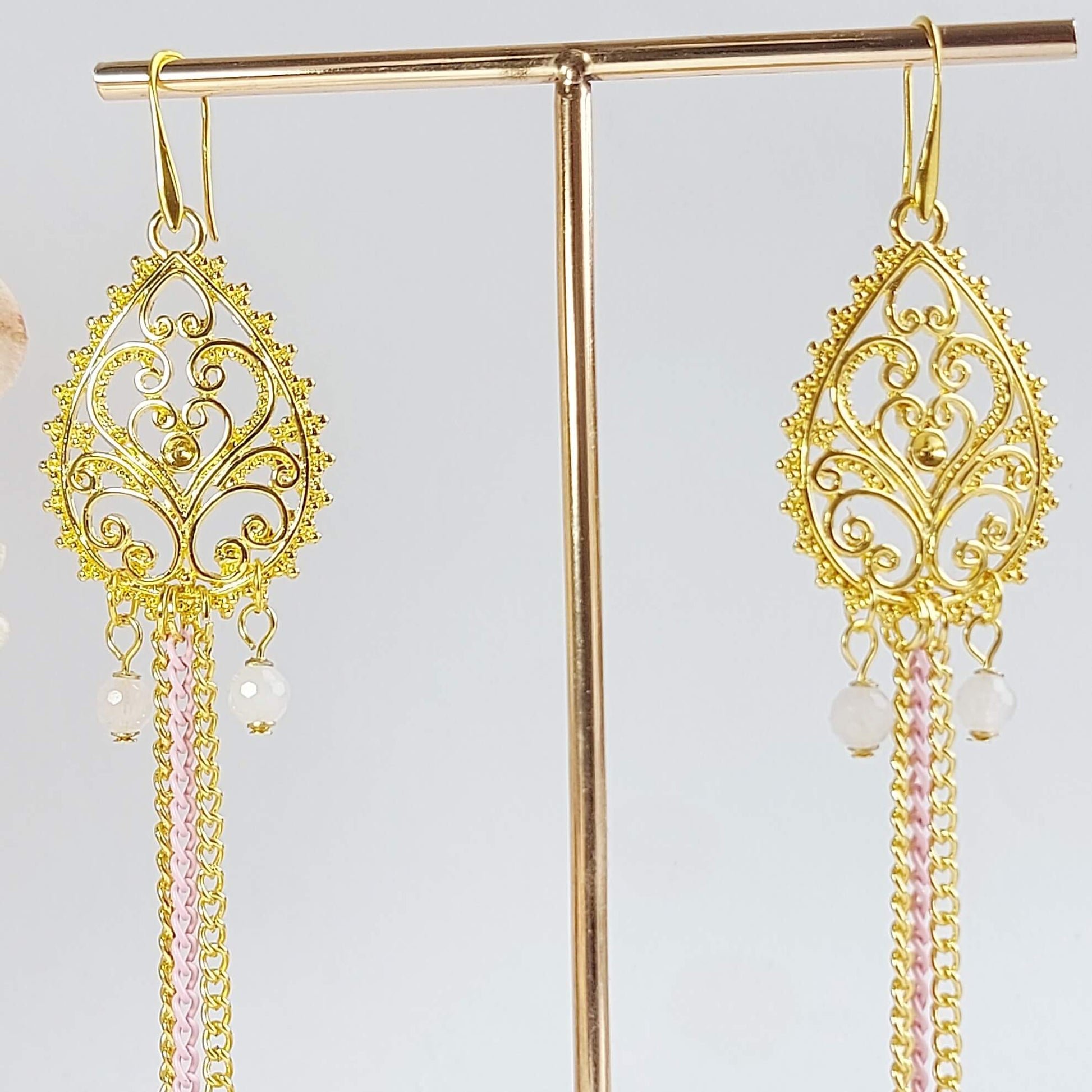 gold colored earrings with rose quartz and hematite
